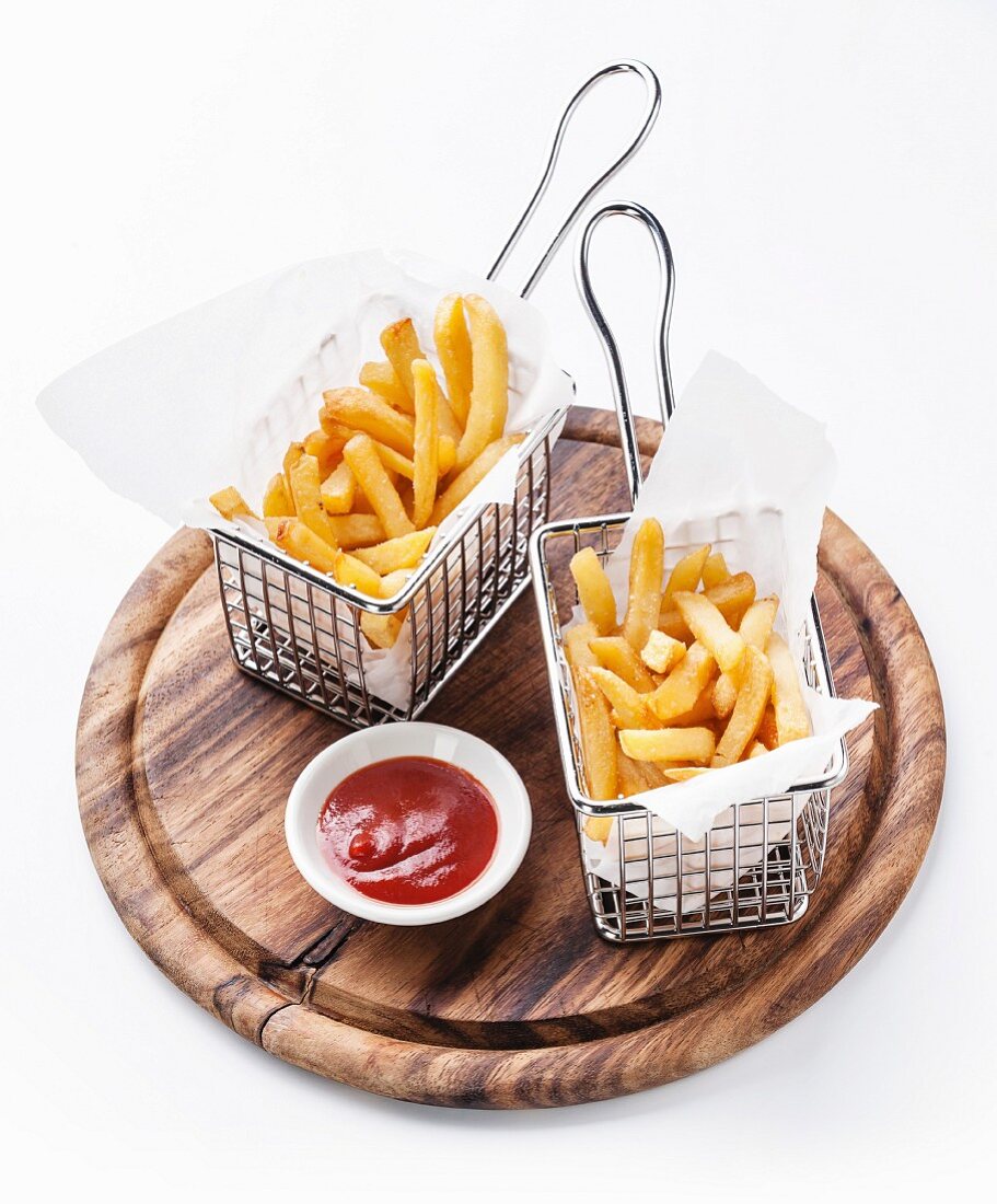 French fries in baskets for serving on white background