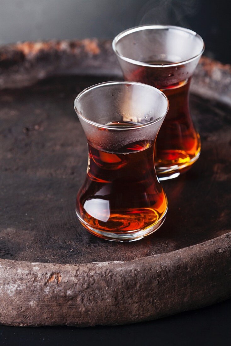 Hot tea in Turkish tea cup on dark background