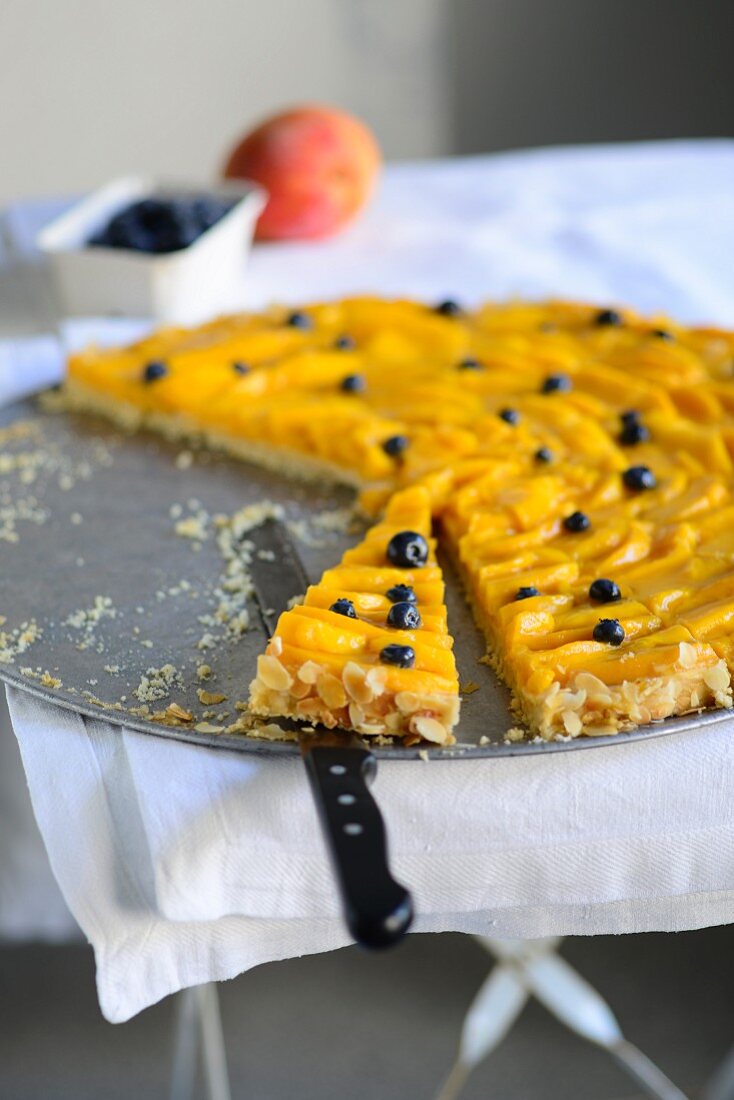 Peach cake with blueberries, sliced