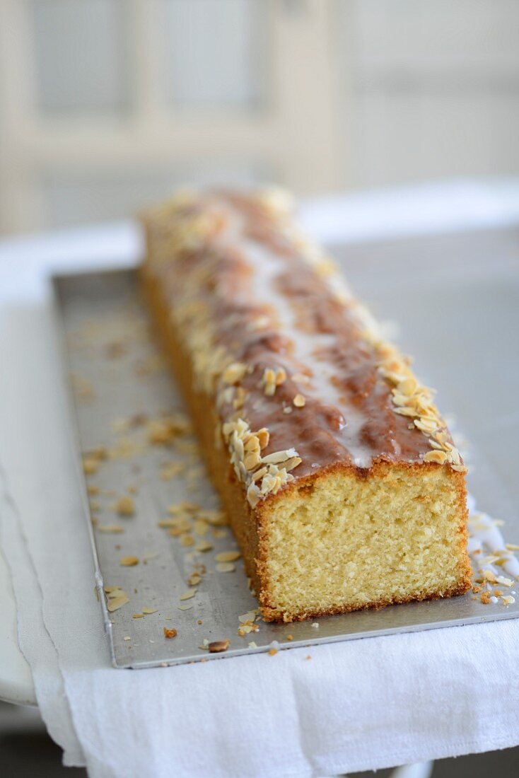 Lemon cake with almond flakes and a sugar glaze