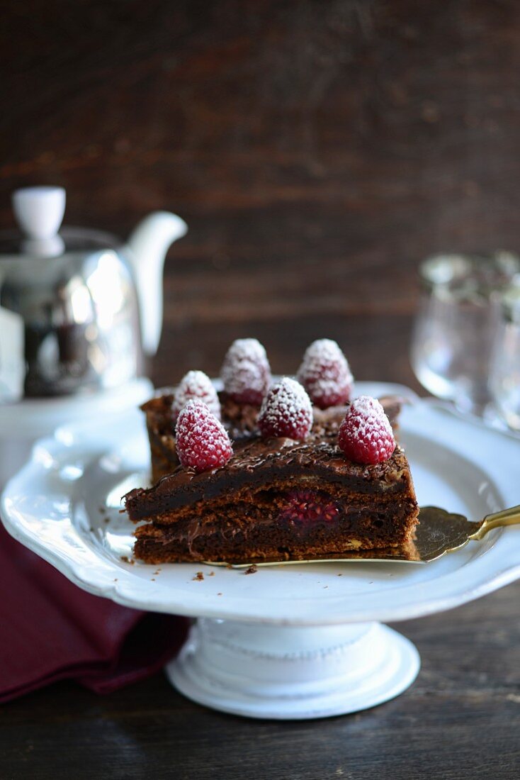 Chocolate cake with raspberries and icing sugar
