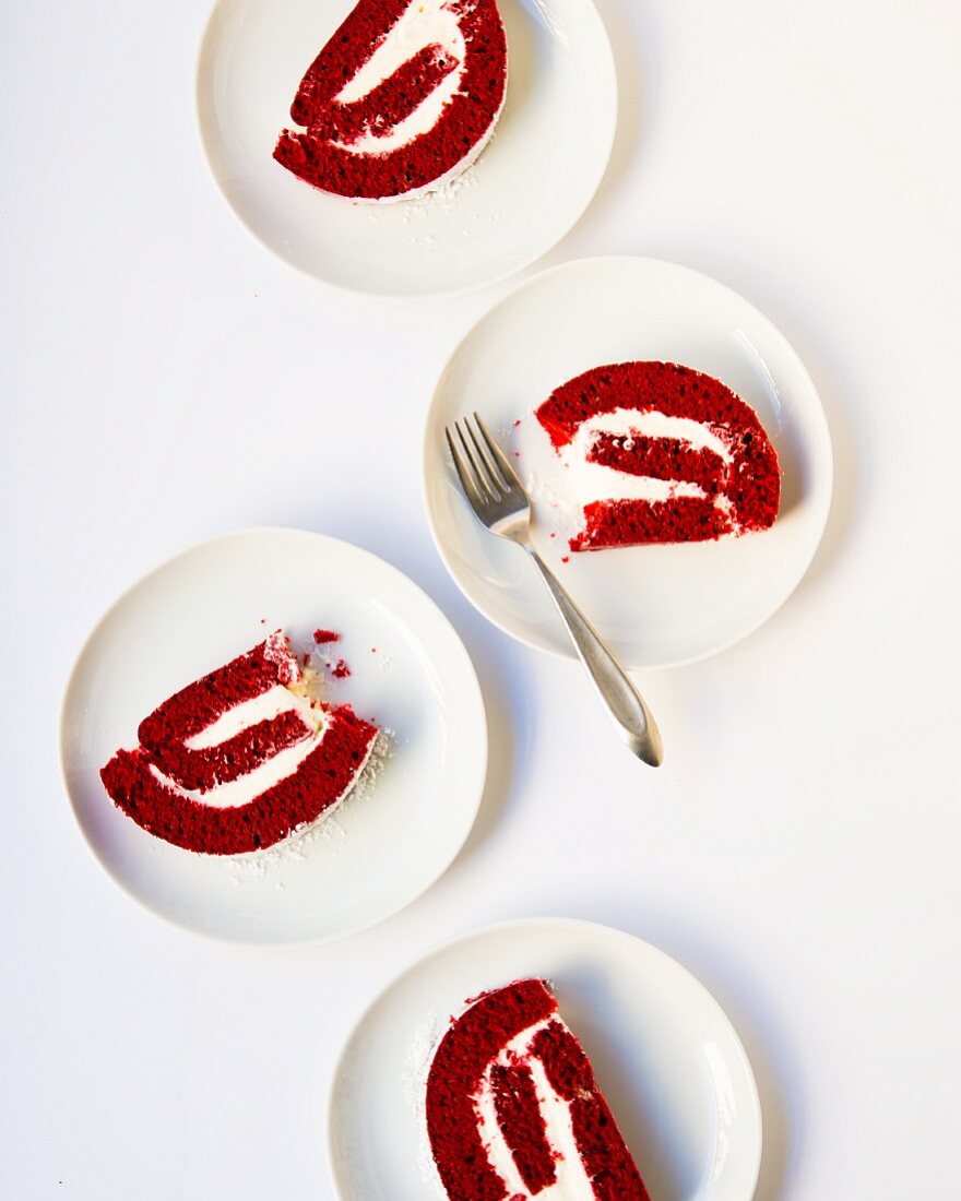 Slices of red velvet sponge cake on dessert plates