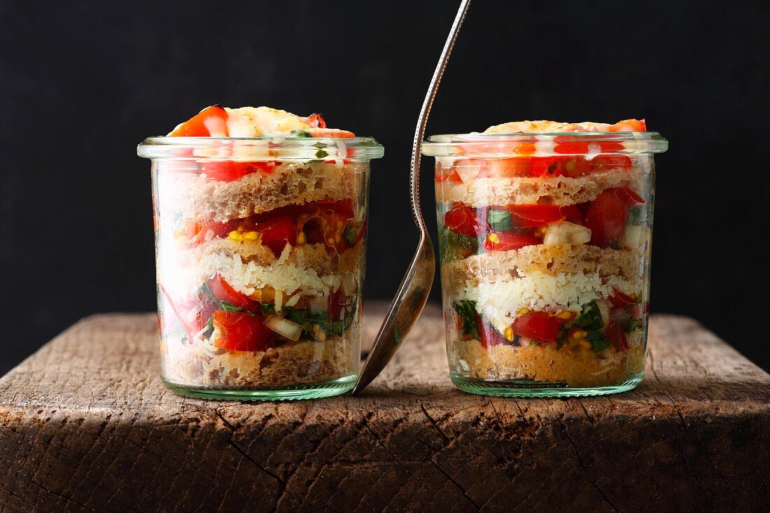 Layered bread with cherry tomatoes in a glass