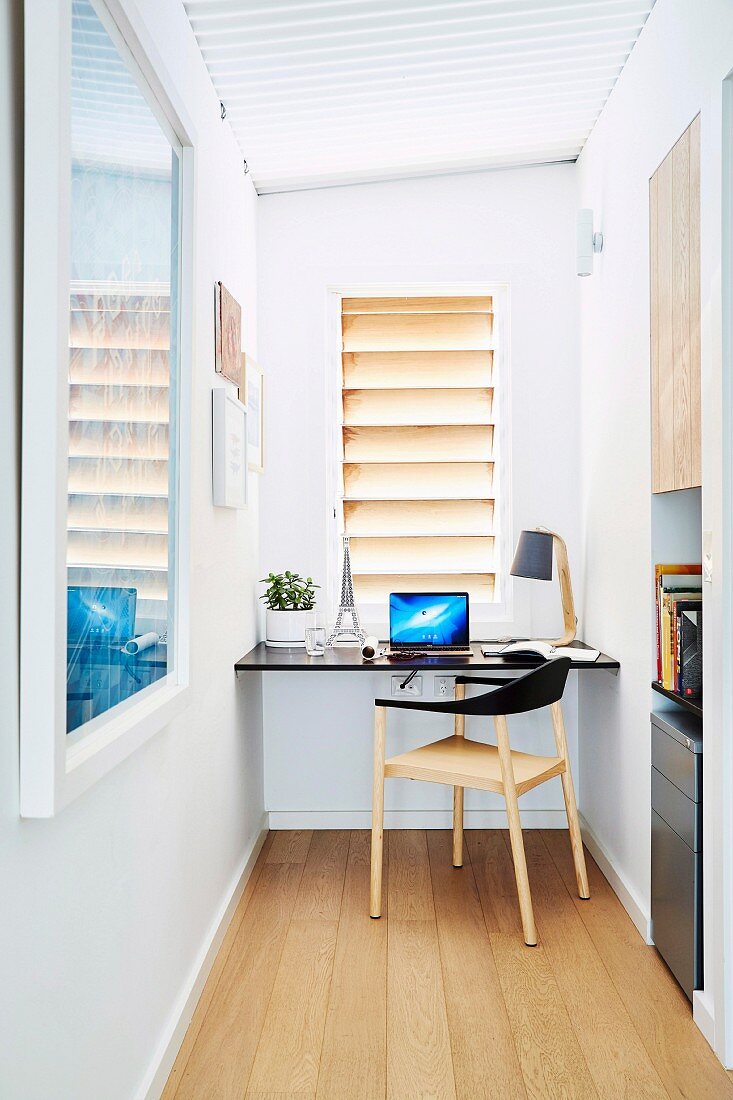 Narrow home office with table top and chair