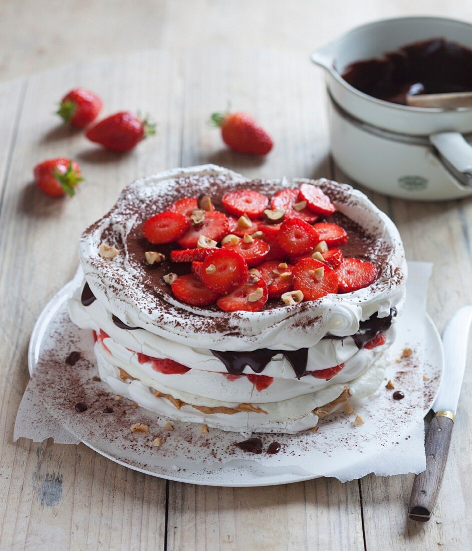 Meringue cake with strawberries, chocolate and nuts