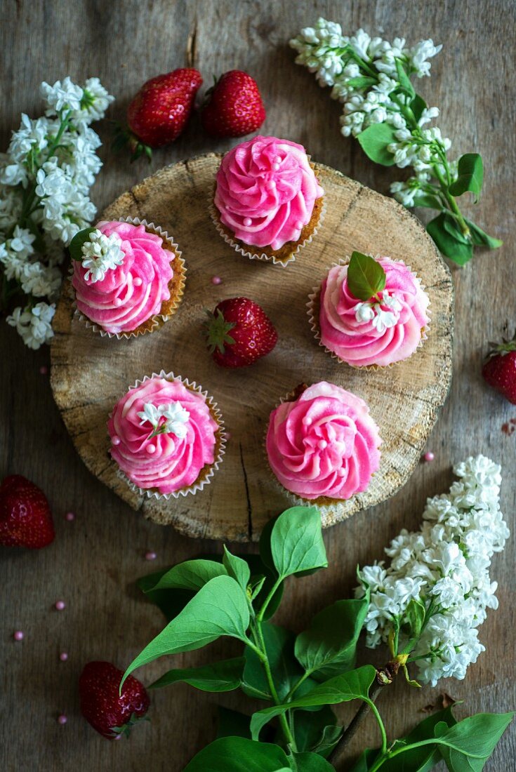 Pink buttercream cupcakes with strawberries