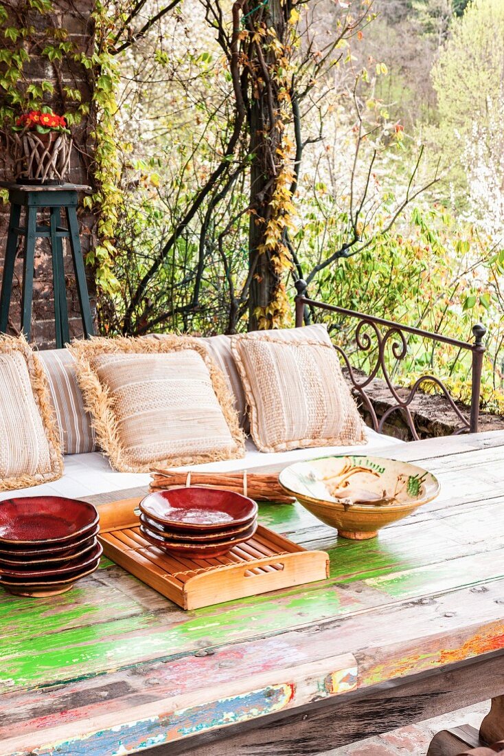 Rustic table and bench on vintage-style terrace