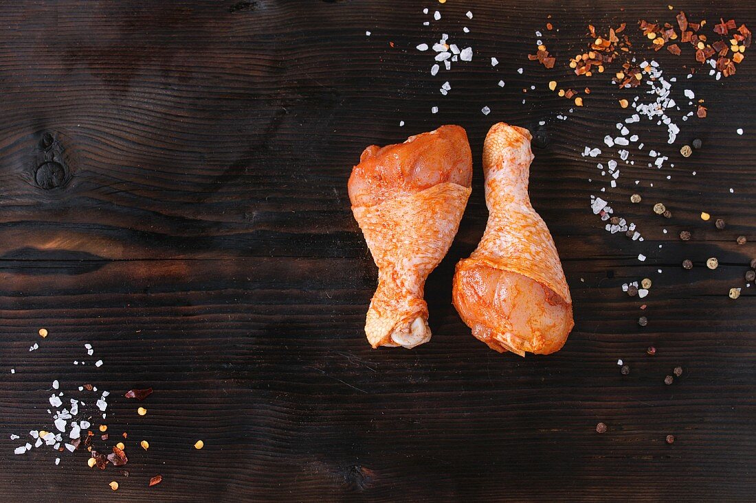 Raw Marinated chicken meat legs for BBQ with seasoning salt and pepper