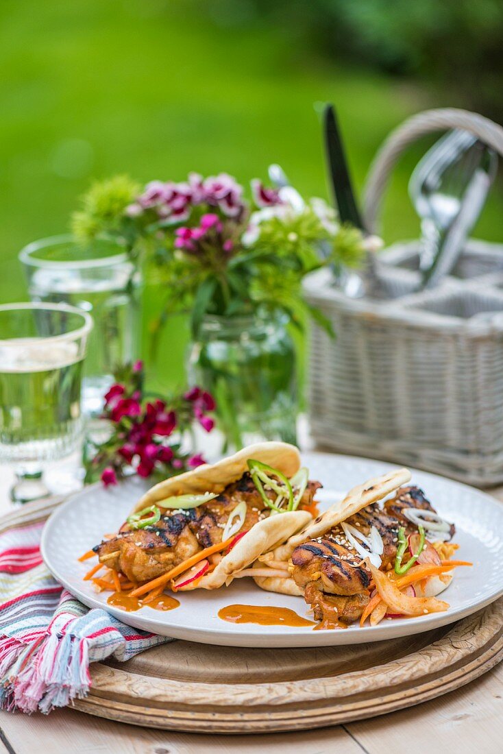 Korean grilled chicken kebabs with kimchi in pitta bread