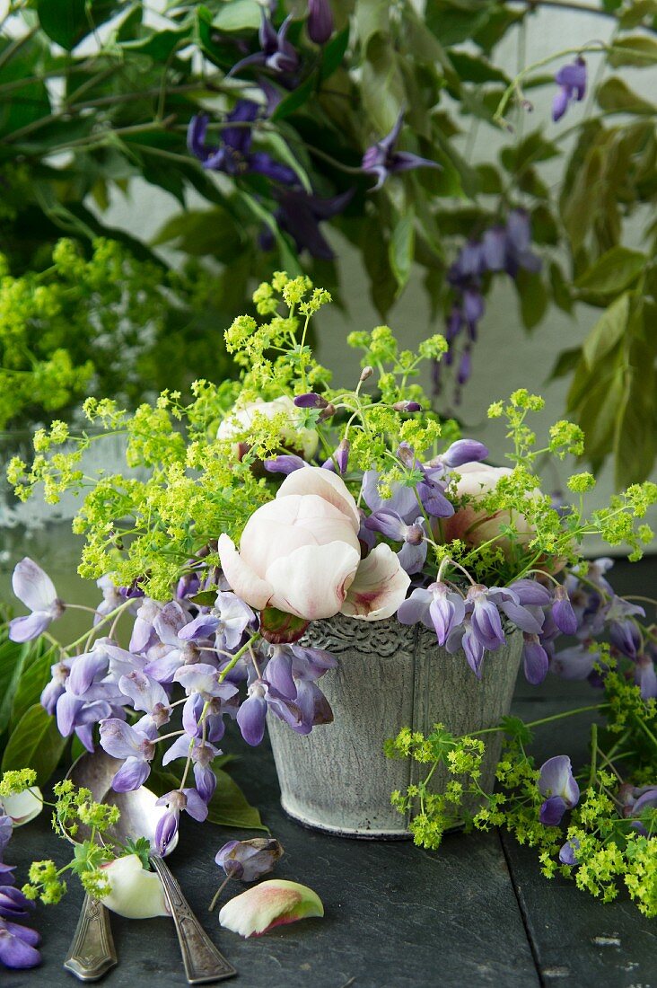 A bouquet of wisteria, peonies and lady's mantle