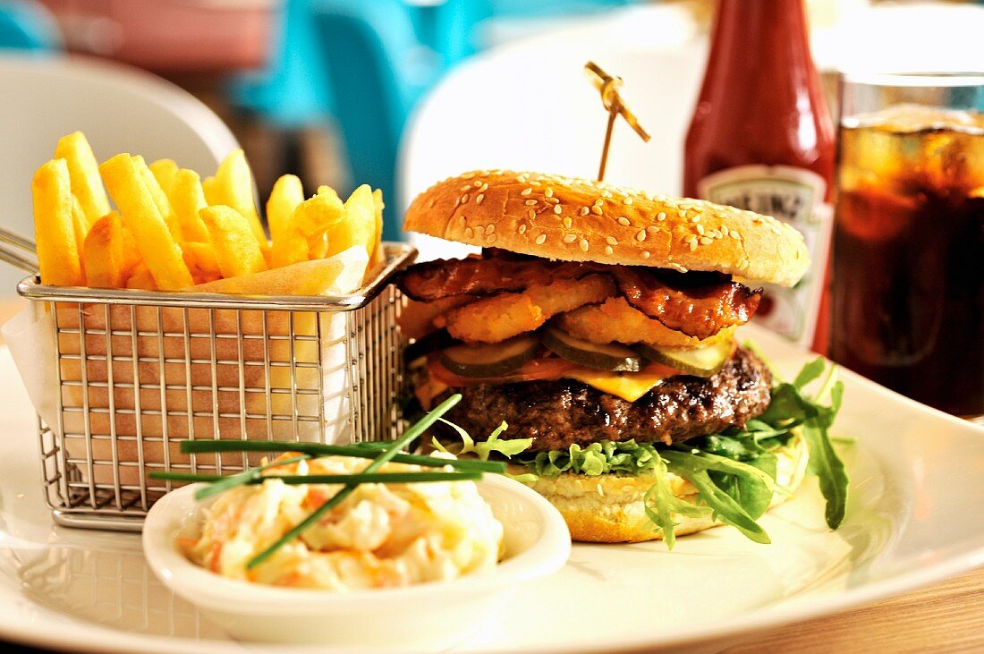 Hamburger with french fries, cole slaw, ketchup and Coke