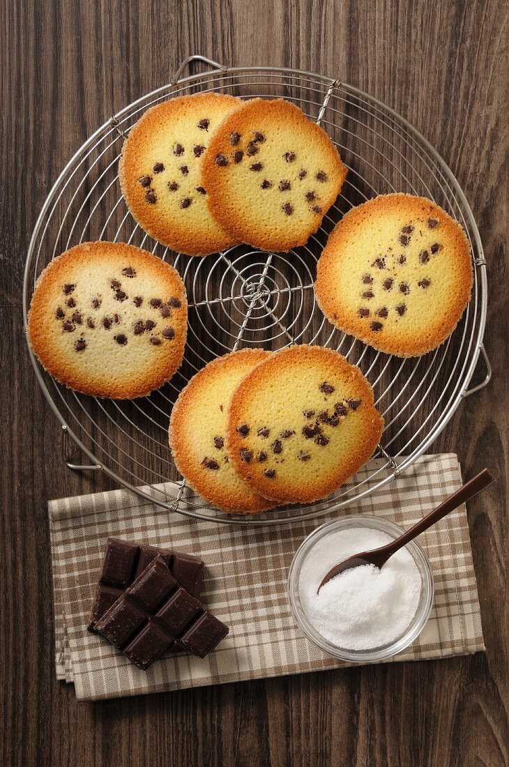 Tuiles with chocolate chips on a cake rack