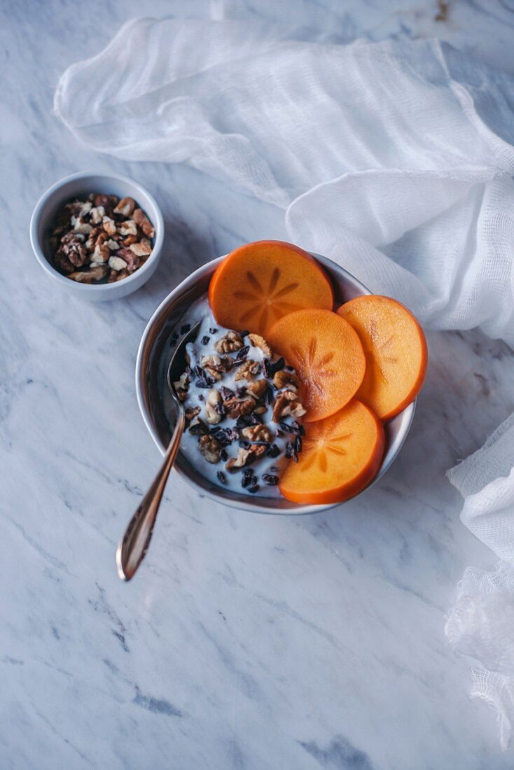 Yogurt with persimmon, walnuts and cacao nibs
