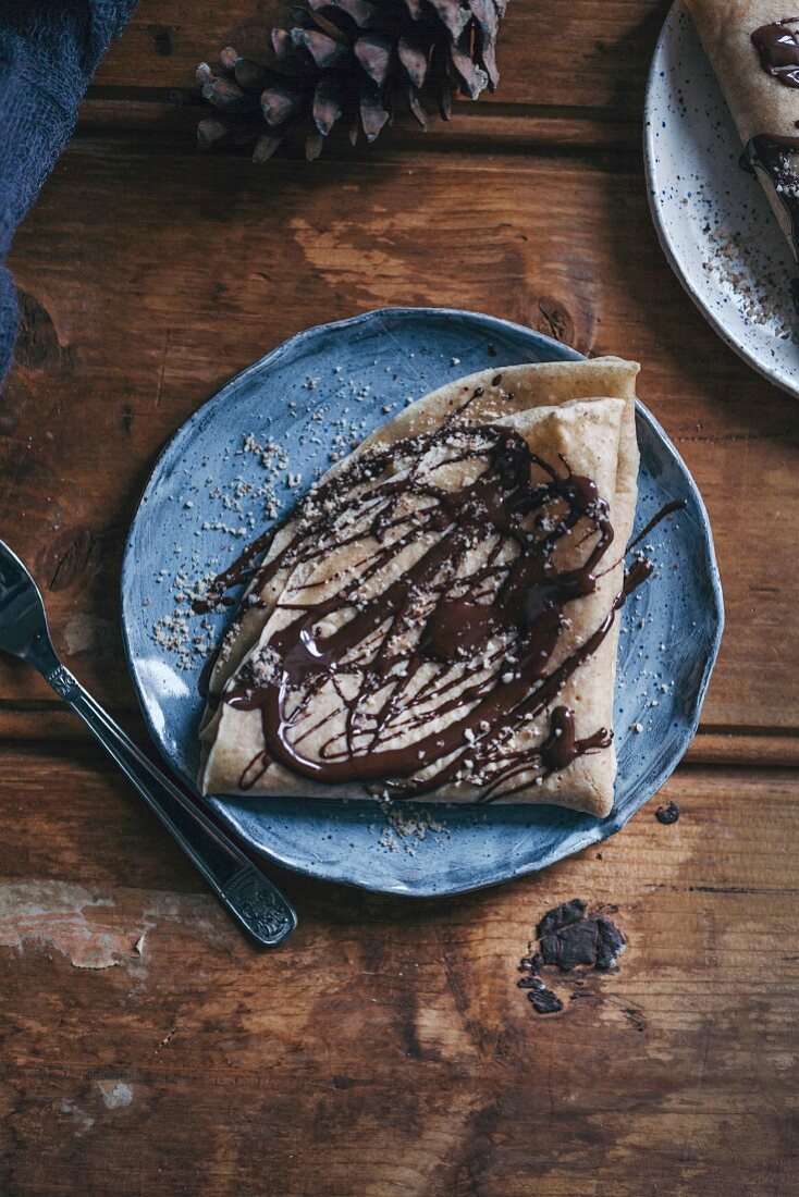 Crepes drizzled with chocolate and ground almonds