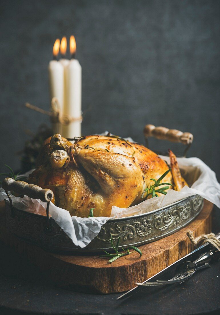 Oven roasted whole chicken with oranges, bulgur, rosemary and decorative candles
