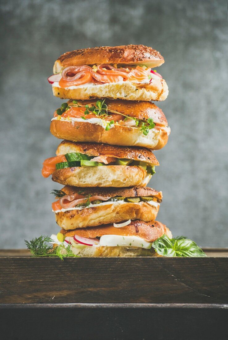 Heap of Bagels with salmon, eggs, vegetables, capers, fresh herbs and cream-cheese