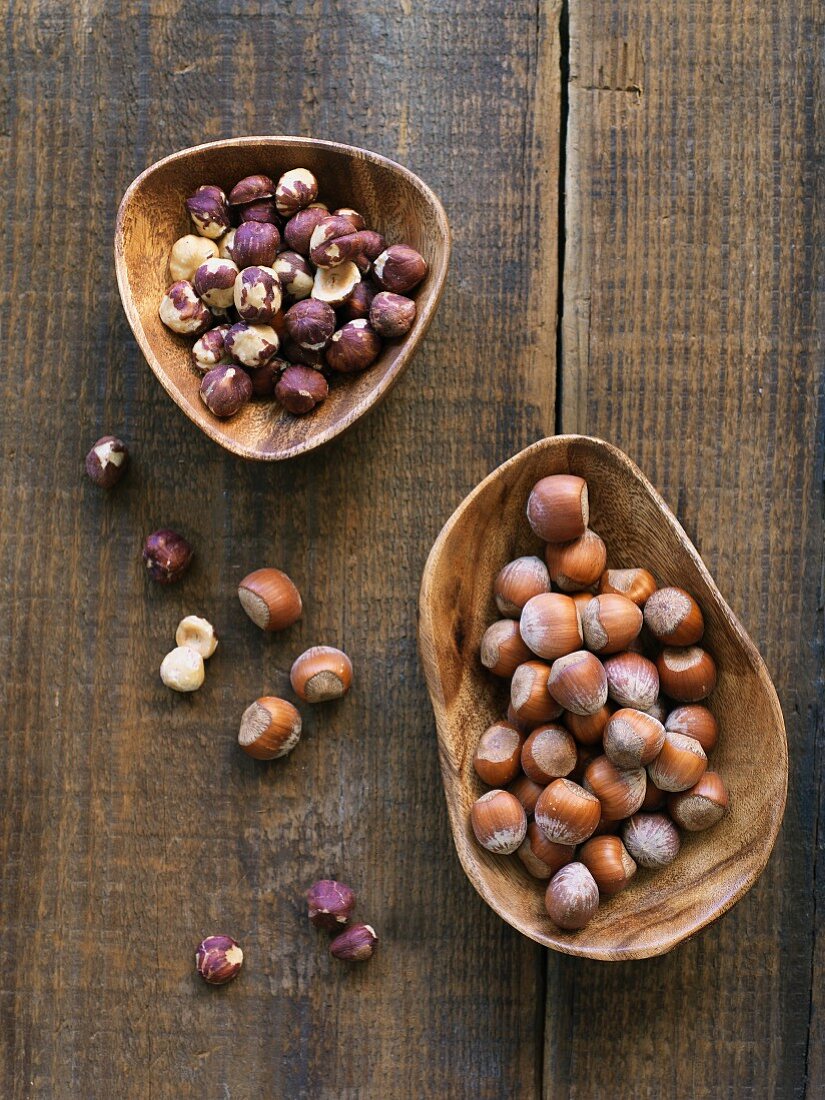 Hazelnuts shelled and unshelled on wood