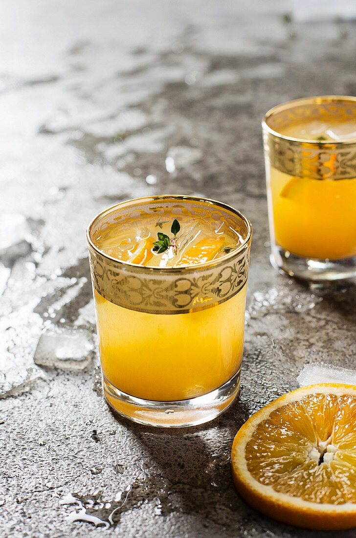 Cocktail with orange juice on grey background