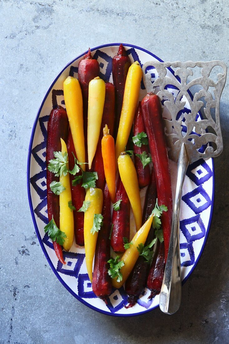 Honey glazed rainbow carrots on a plate, top view