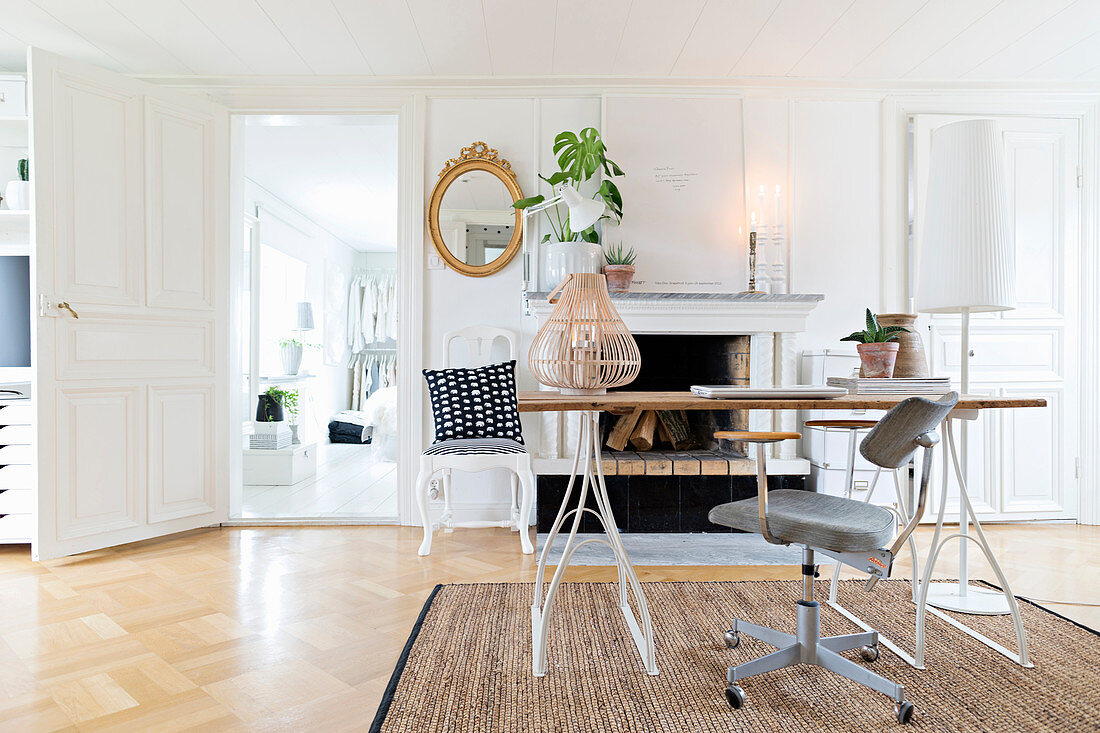 Desk in front of open fireplace in connecting room