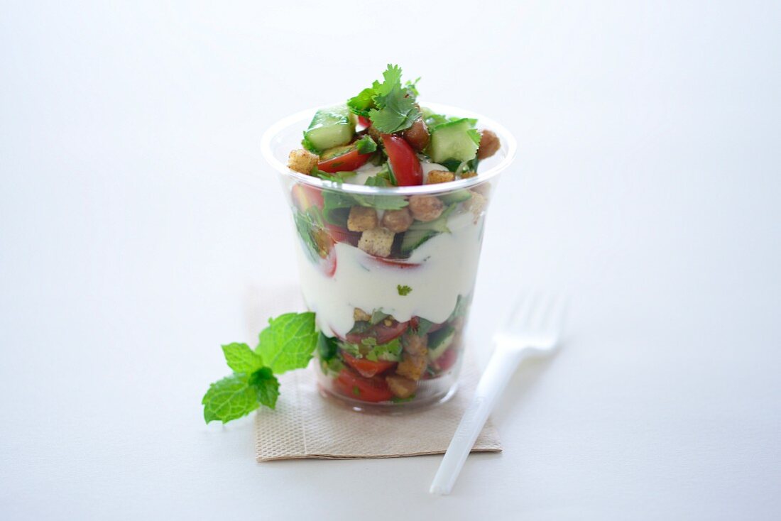 Garden salad with croutons and a yoghurt dressing in a takeaway cup