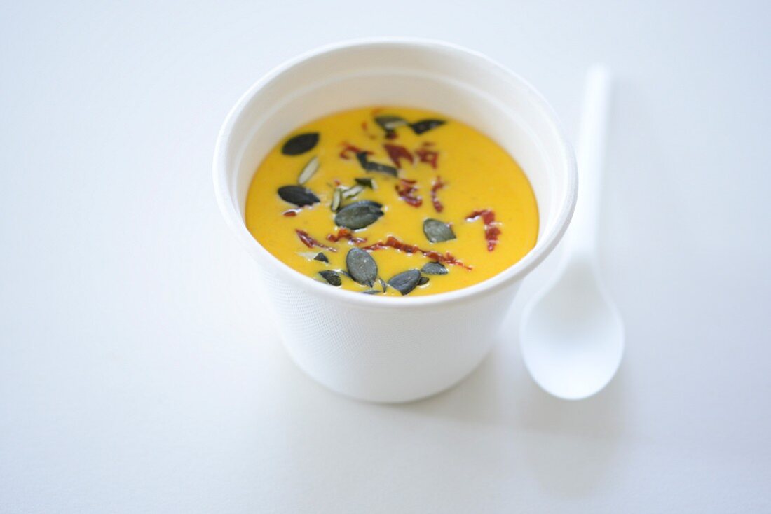 Pumpkin soup in a styrofoam takeaway cup