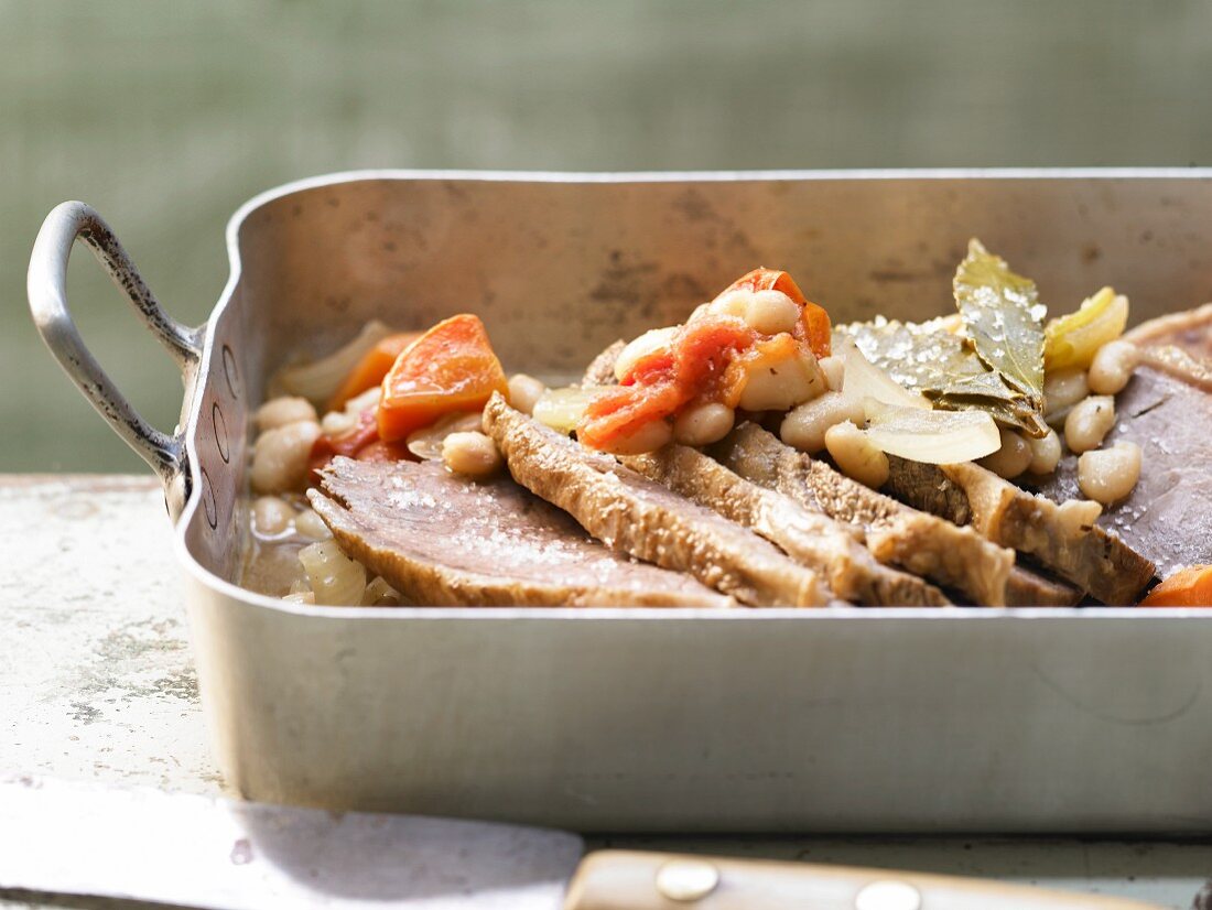 Oven cooked veal with beans and tomatoes