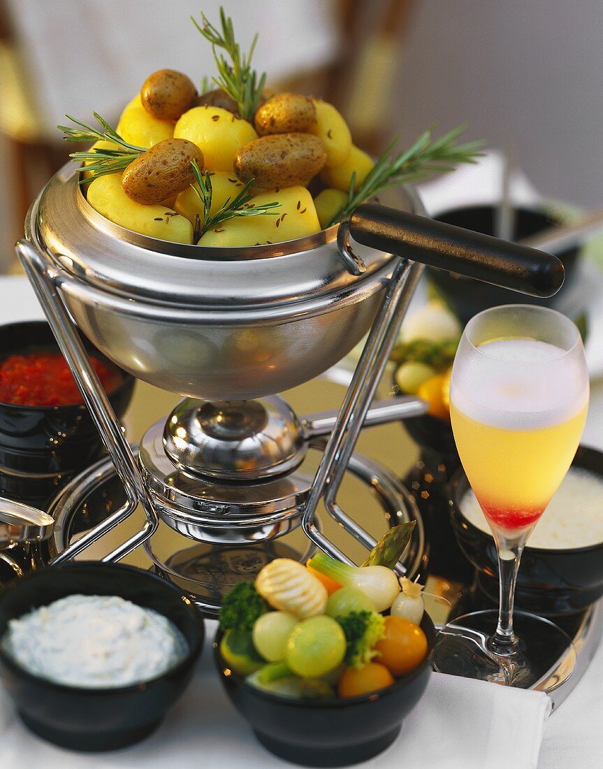 Fondue Pot with Potatoes and a Bowl of Pickled Vegetables