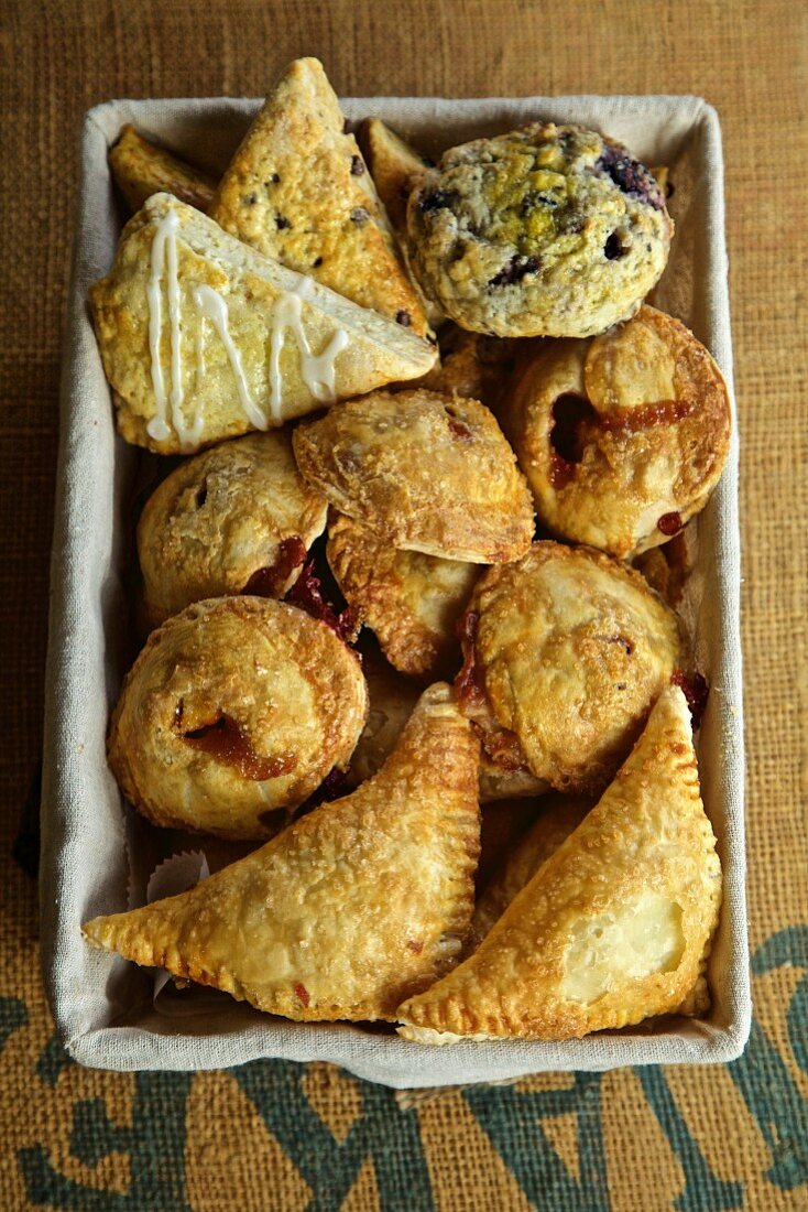 Assortment of baked goods, apple turnovers, scones, muffins