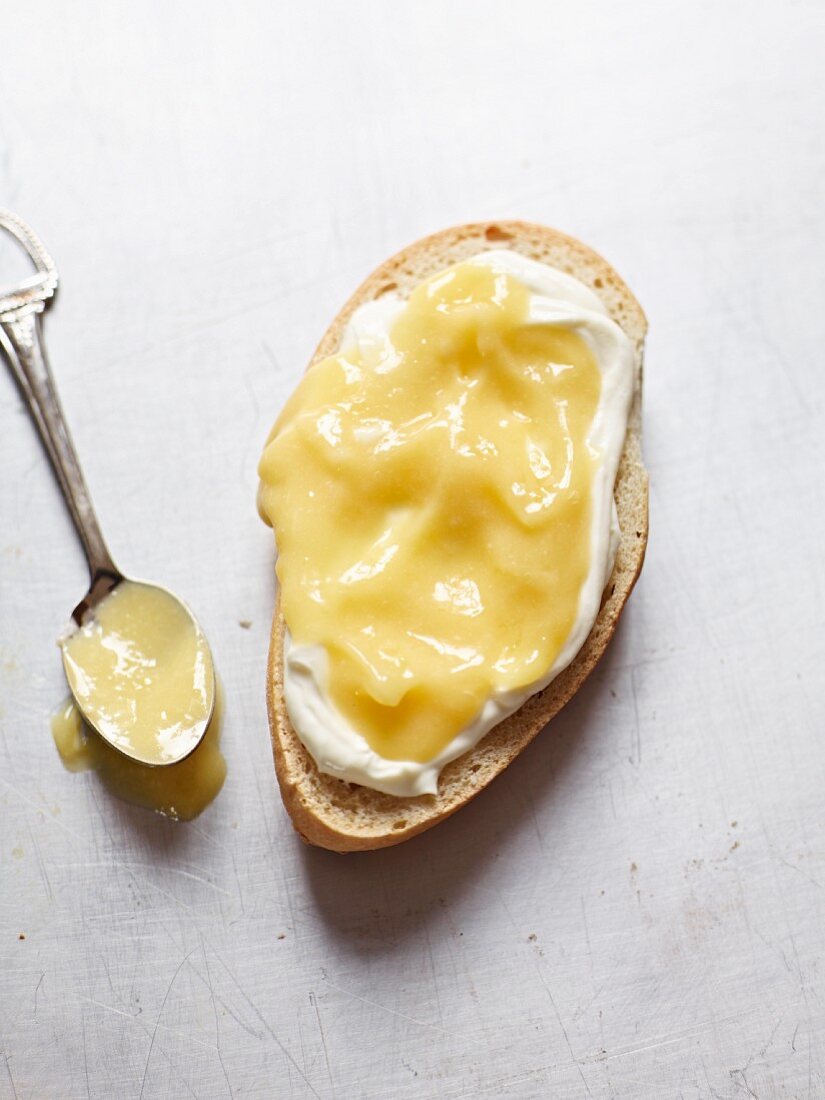 A slice of bread spread with lemon curd