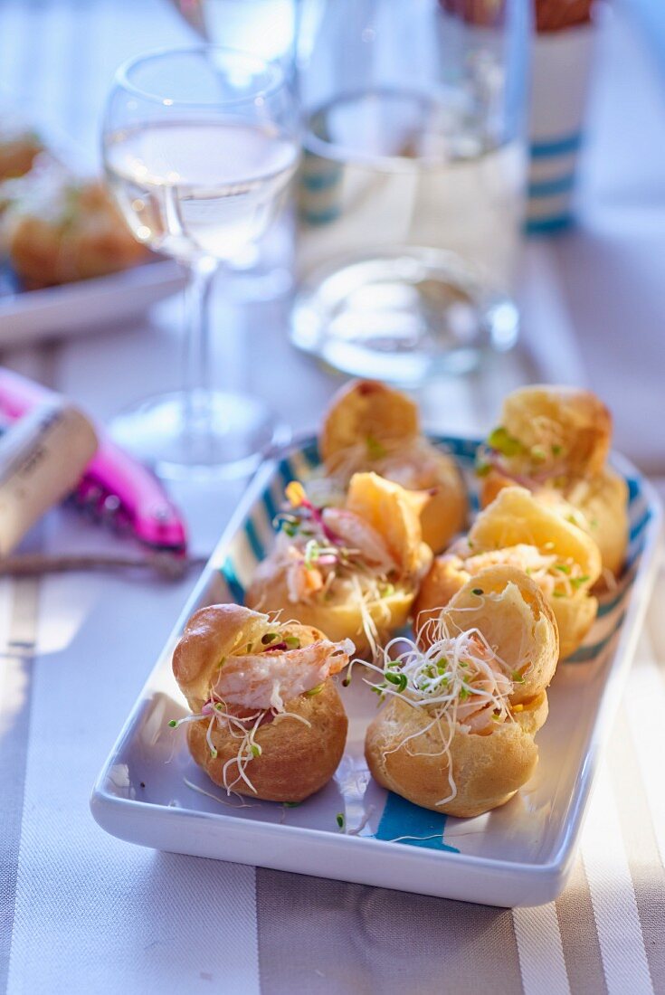 Spicy mini profiteroles filled with shrimps and sprouts