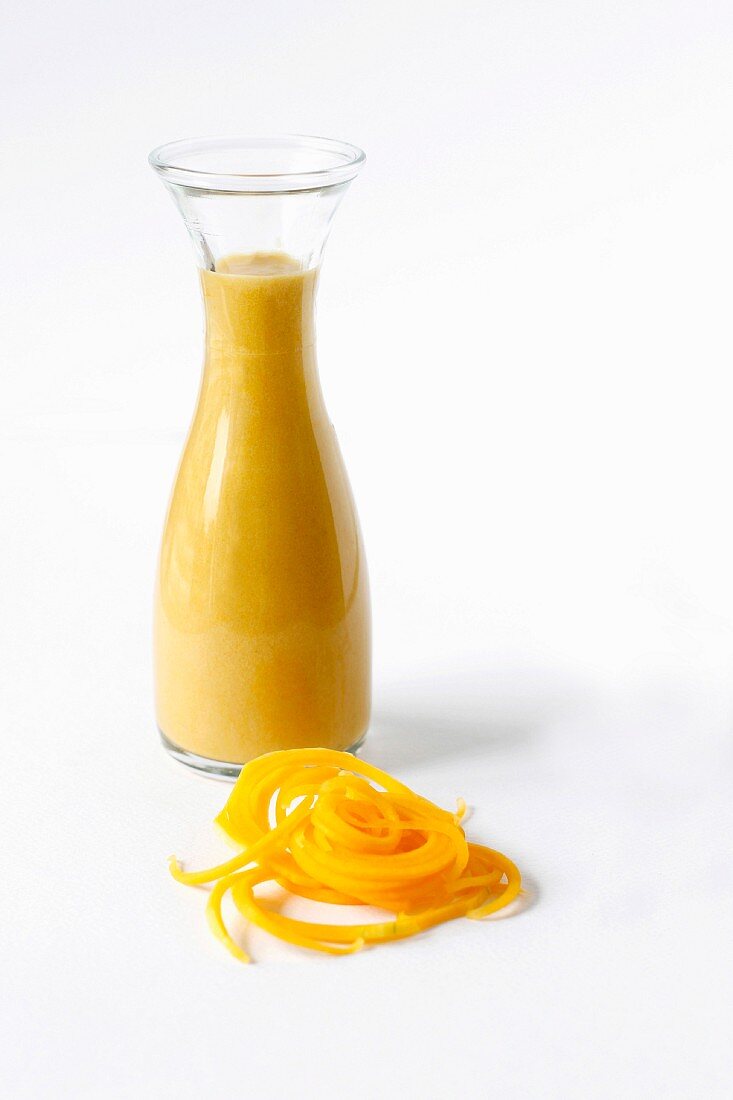 Butternut soup in a glass bottle with butternut noodles and space for text