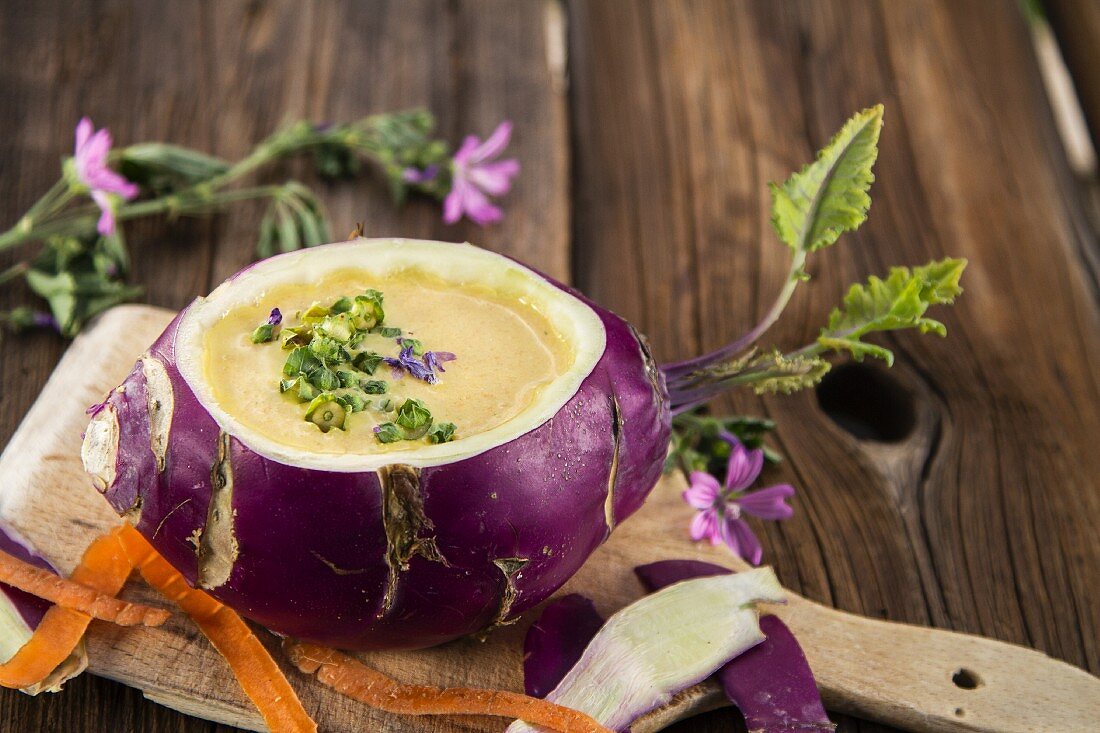 Vegetable cream soup with mallow served in a hollowed out kohlrabi