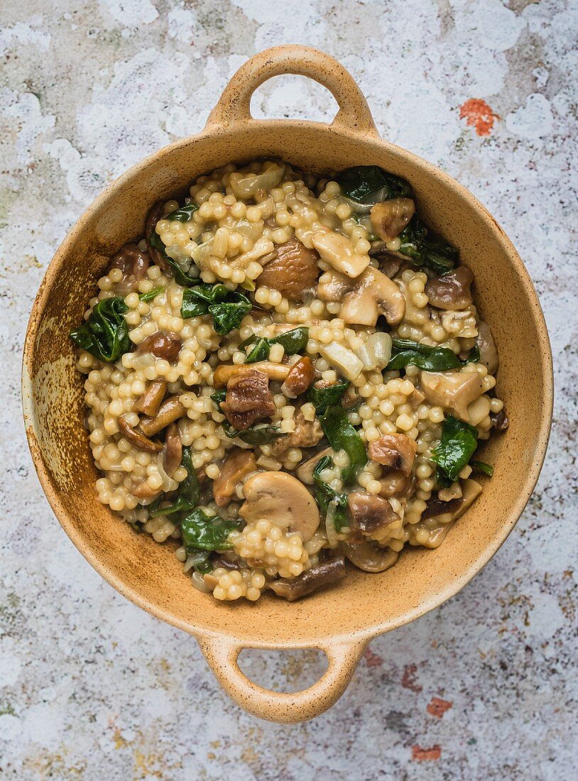 Couscous risotto with wild mushrooms, spinach and chestnuts