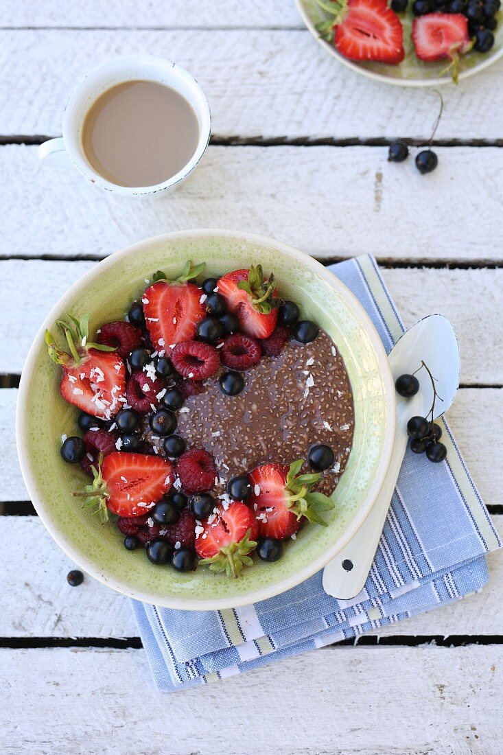 Summer breakfast - chocolate coconut chia pudding with fruits on top.