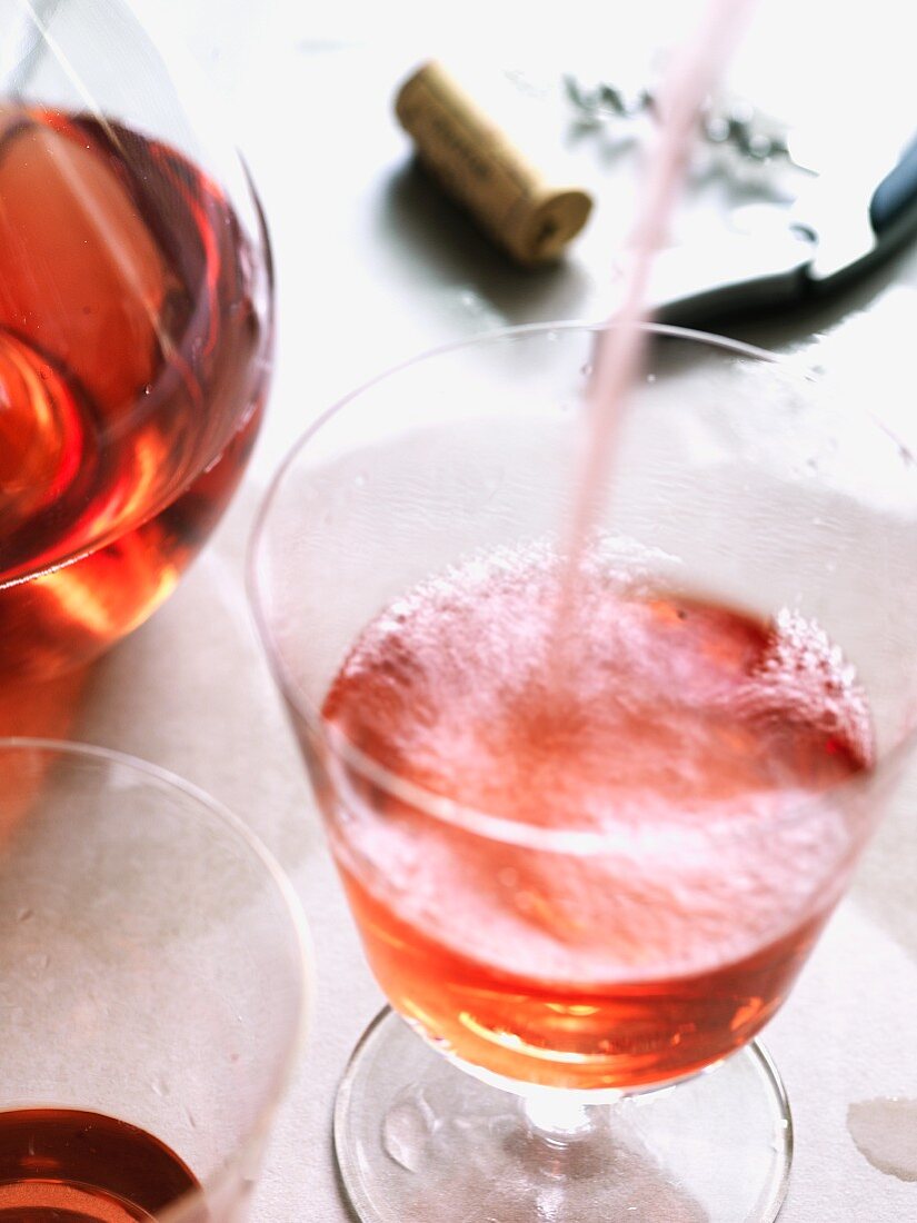 Pouring rosé wine into a glass