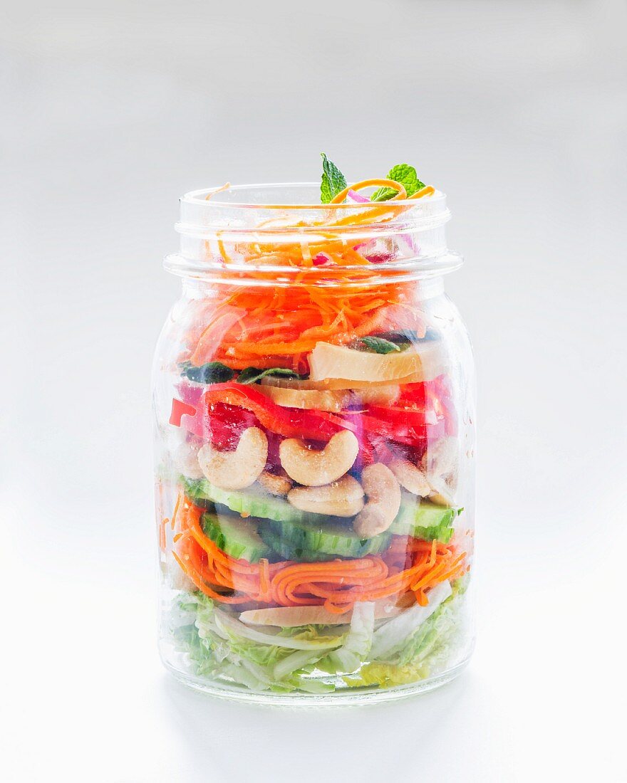 Vegetable salad with cashew nuts in a glass jar