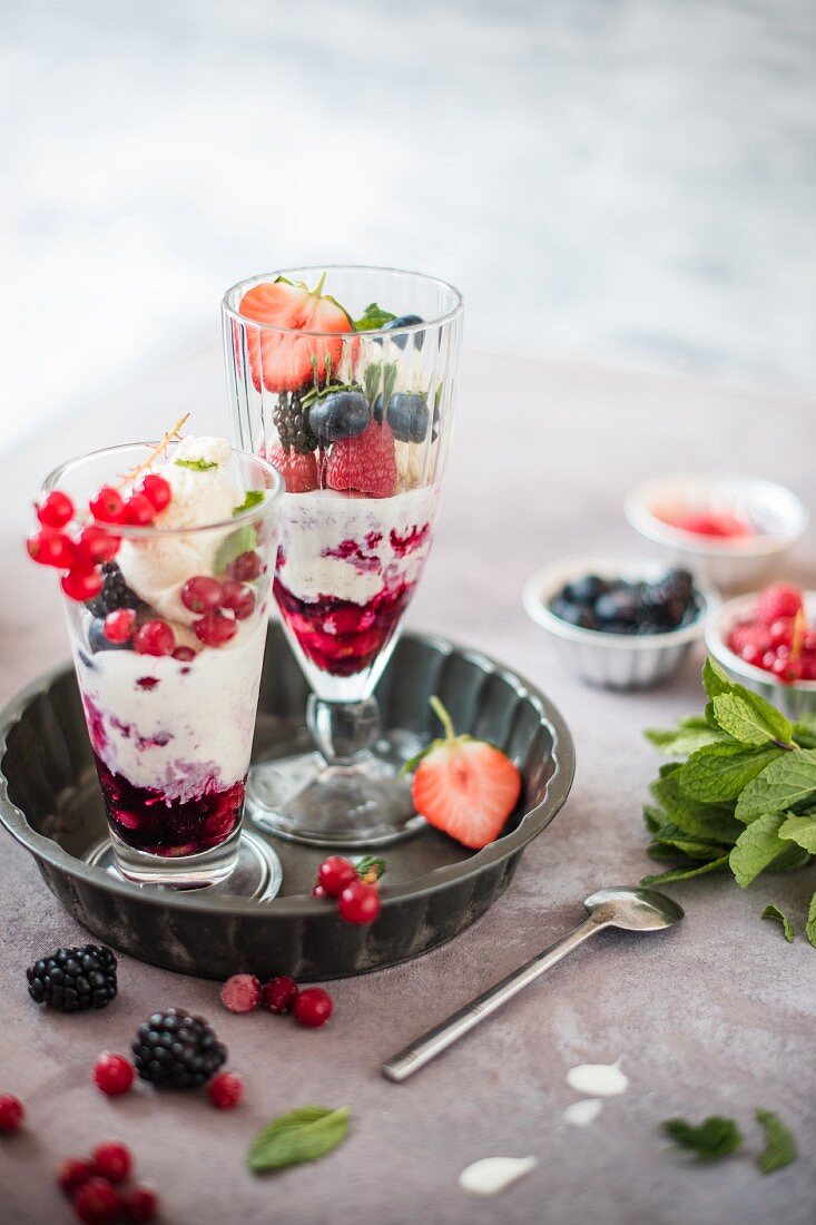 Homemade vanilla gelatto with red bery sauce and fresh berries