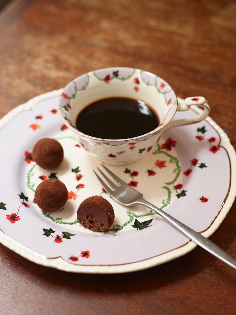 A cup of coffee and chocolate pralines