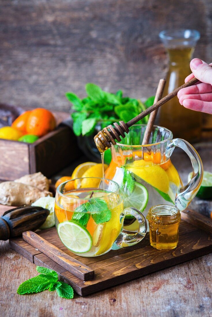 Detox water with citrus fruits, ginger and honey