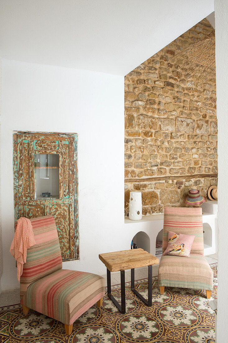 Striped easy chairs on patterned tiled floor in seating area