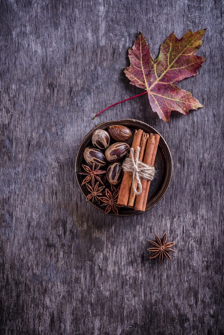 Various spices with an autumn leaf