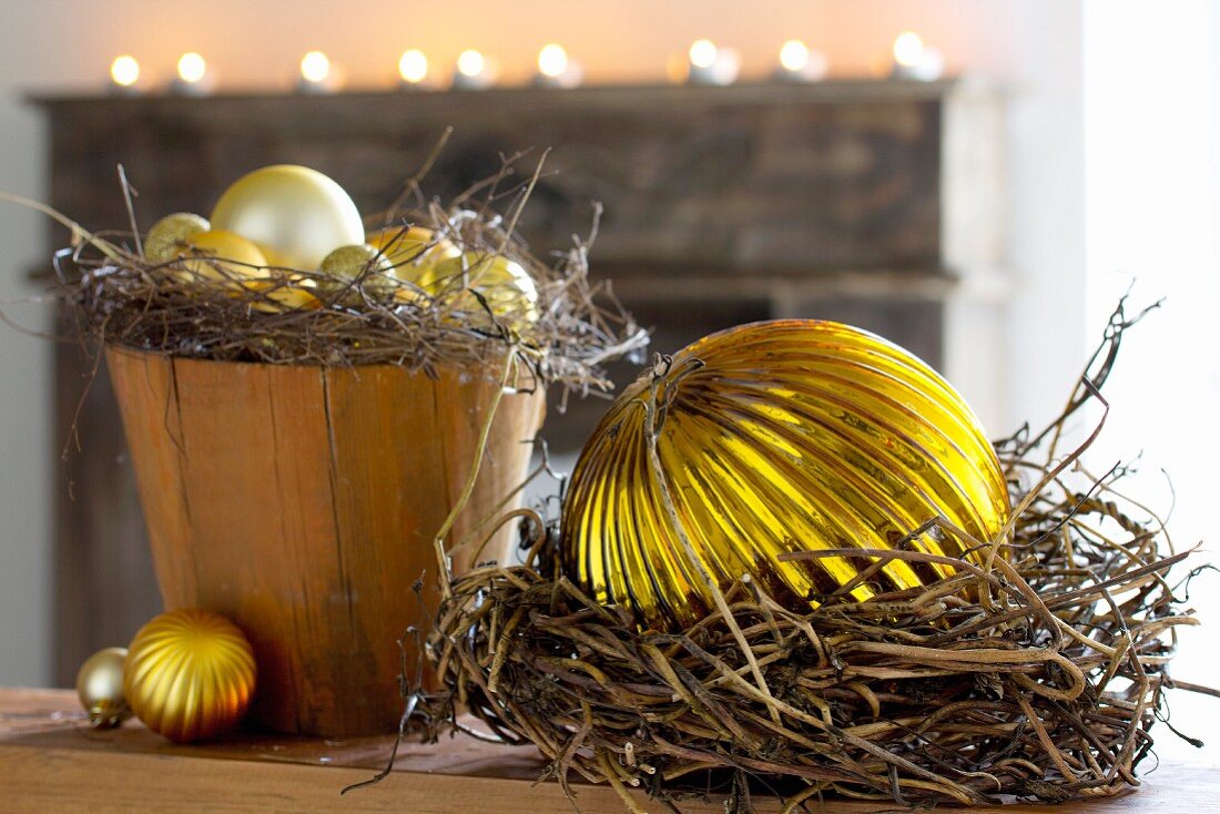 Weihnachtsdekoration mit goldfarbenen Christbaumkugeln in Übertopf und Kränzen