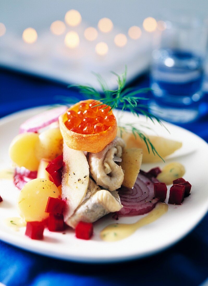 A plate of herring salad with caviar