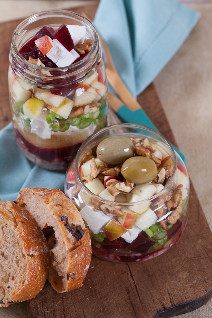 Beetroot with goat's cheese, apple, walnuts, olives and onions in a glass jar