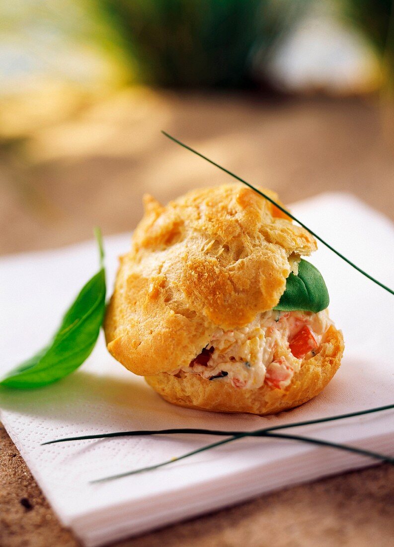 A single choux pastry in a beach setting