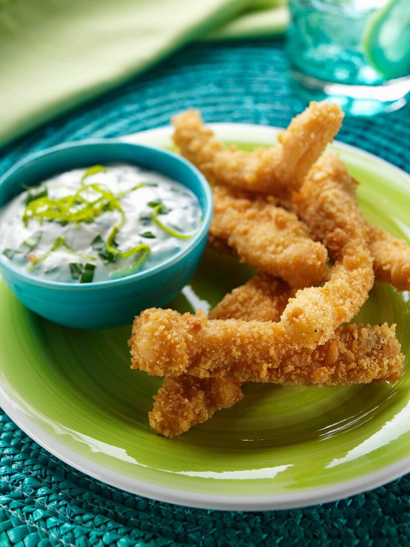 A plate of salmon goujons with dipping sauce