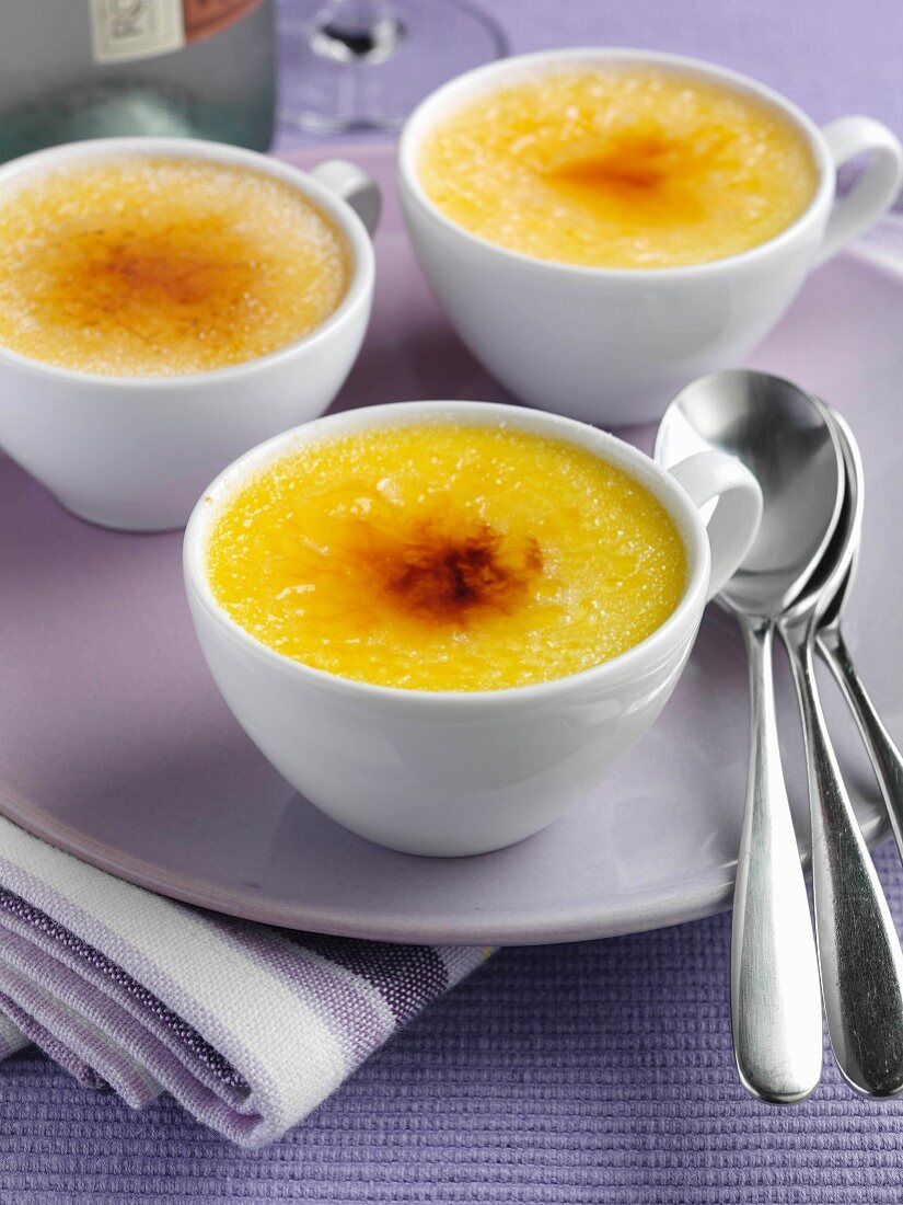 Three white cups of Creme brulee