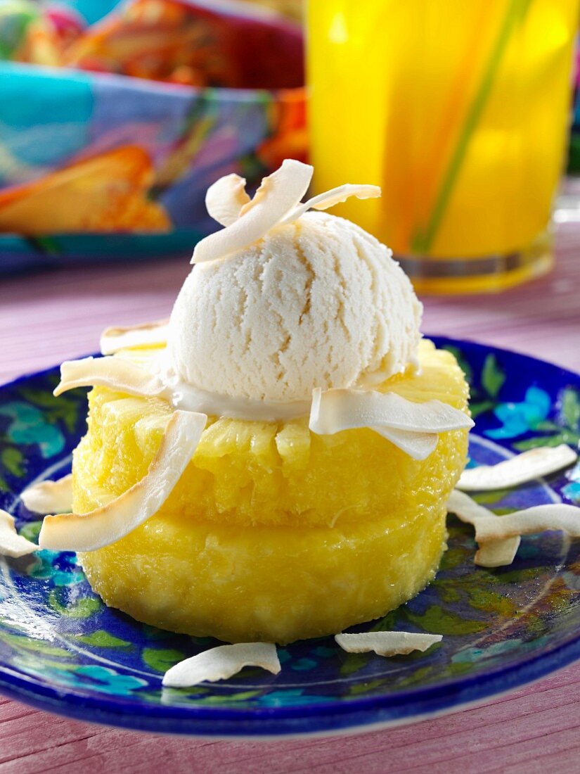 A scoop of coconut ice cream on pineapple rings editorial food