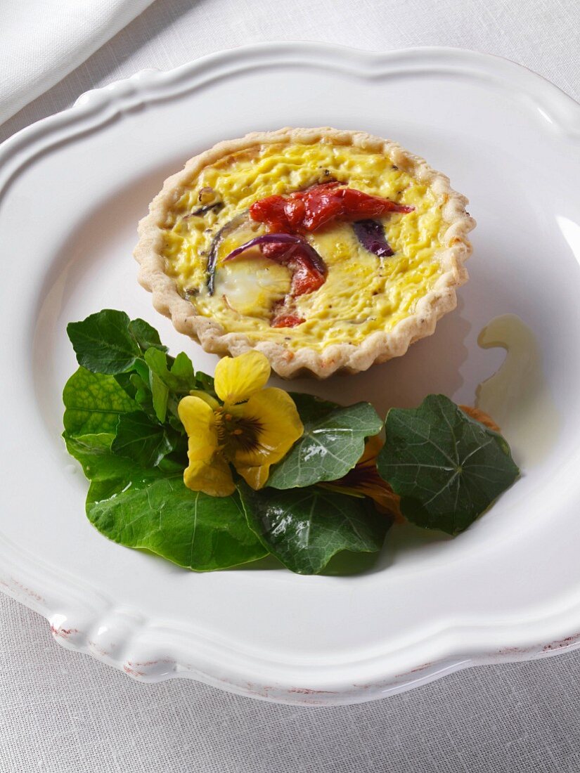 Red pepper and red onion tart with nastutiums editorial food